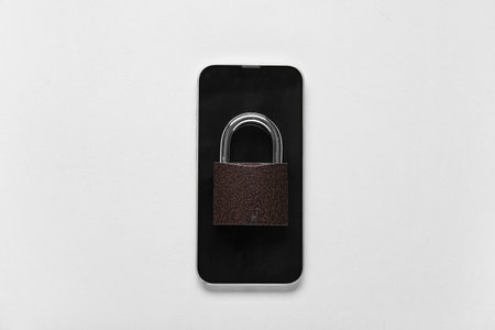 Mobile phone with lock on white background. Crime conceptの写真素材