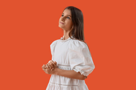 Dreamy teenage girl on orange backgroundの写真素材