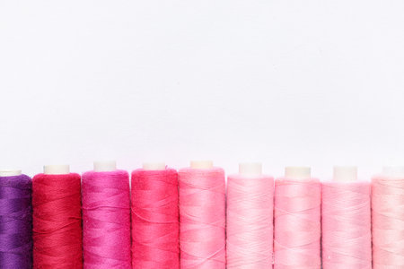 Colorful thread spools on white backgroundの写真素材
