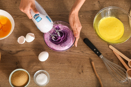 Female hands using mixer on table in kitchen, top viewの写真素材