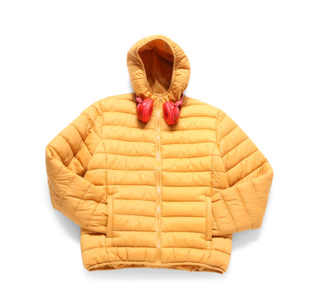 Stylish puffer jacket with headphones on white backgroundの写真素材