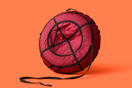 Snow tube on orange backgroundの写真素材