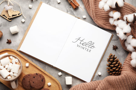 Notebook with text HELLO WINTER, cocoa, cookies and sweater on grunge backgroundの写真素材