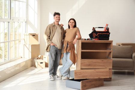 Young couple assembling chest of drawers at homeの写真素材