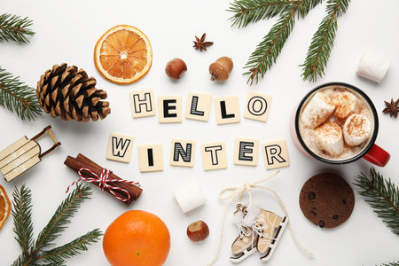 Text HELLO WINTER with nuts, citruses and cocoa on white backgroundの写真素材