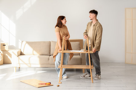 Young couple assembling shelf unit at homeの写真素材