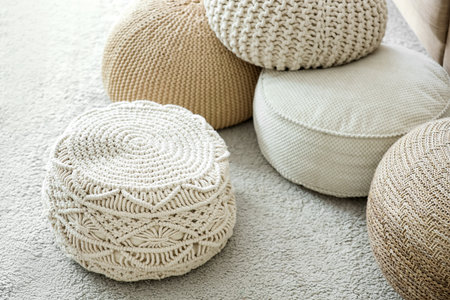 Different poufs on carpet in living roomの写真素材