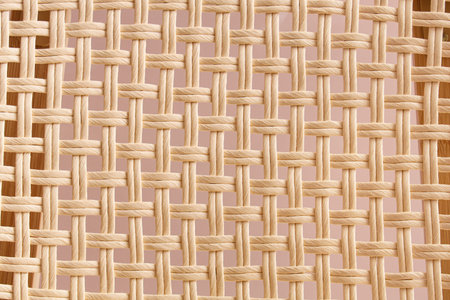 Wicker rattan texture on beige background, closeup