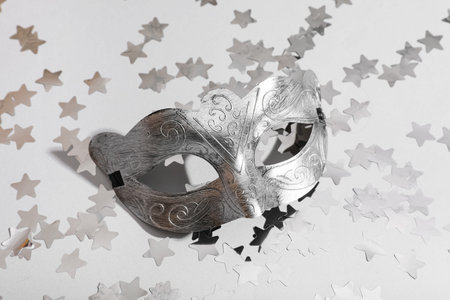 Beautiful carnival mask and confetti on light backgroundの写真素材