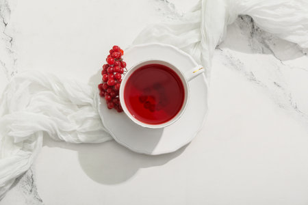 Cup of hot viburnum tea on marble backgroundの写真素材