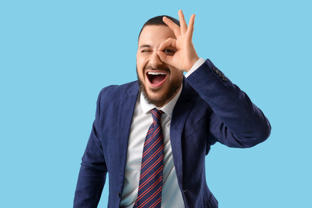 Young businessman on blue backgroundの写真素材