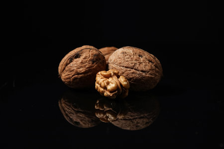 Tasty walnuts on black backgroundの写真素材