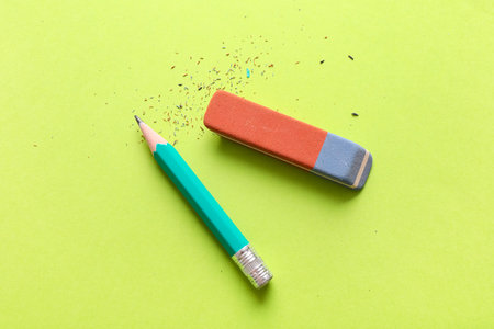 School eraser with pencil on green backgroundの写真素材