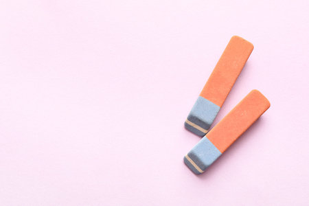 School erasers on lilac background