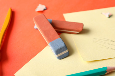 Erasers with stickers on orange background
