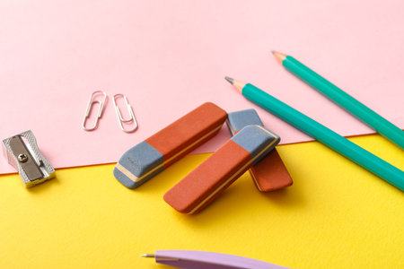 Erasers with stationery on color backgroundの写真素材