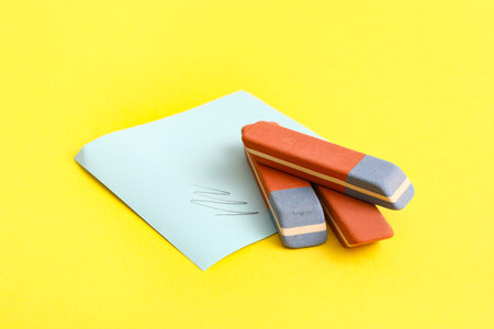 Erasers with sticker on yellow background