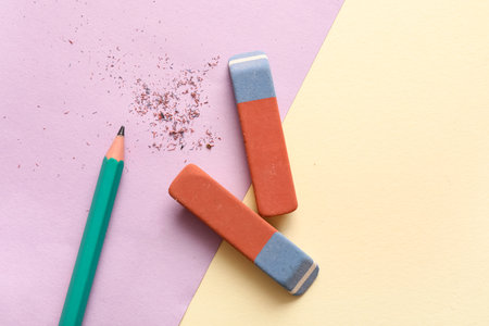 School erasers with pencil on color backgroundの写真素材