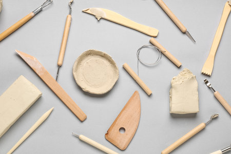 Set of sculptor tools and clay on gray backgroundの写真素材