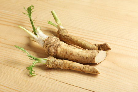 Horseradish roots on wooden backgroundの写真素材