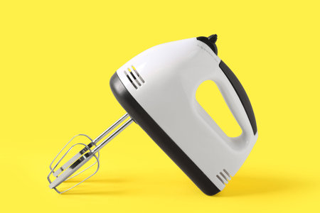 Modern mixer on yellow background