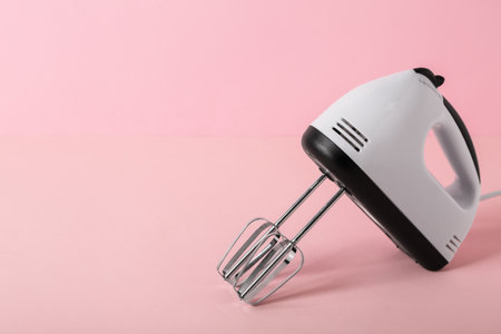 Electric mixer on pink backgroundの写真素材