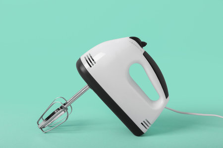 Electric mixer on turquoise backgroundの写真素材