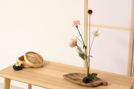 Kenzan with beautiful ikebana on table in stylish room, closeupの写真素材