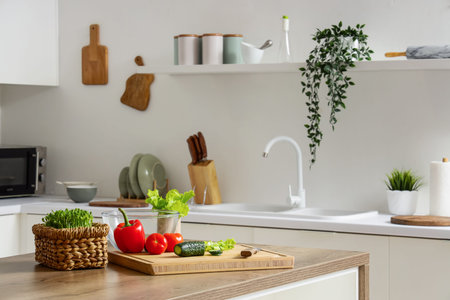 Cutting board with vegetables on table in kitchen