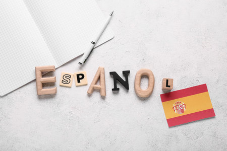 Spanish language learning with espanol letters, spain flag, notebook, and pen on white background