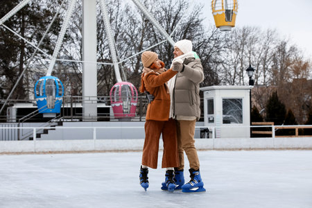 Lovely young couple on skating rink