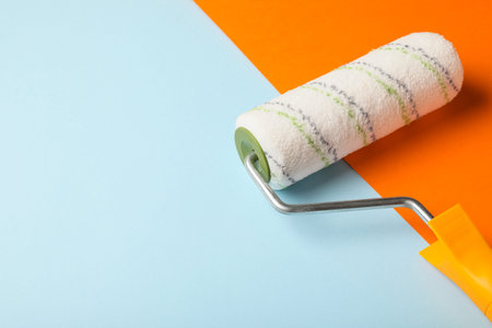 Paint roller on color background