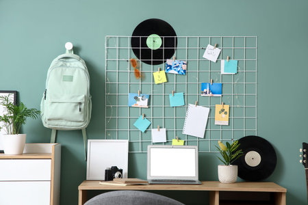 Interior of stylish office with workplace, pin board and vinyl disks