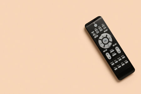 Modern TV remote control on beige background