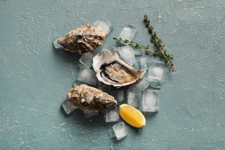 Fresh raw oysters on ice with lemon and thyme, gourmet seafood delicacy, healthy appetizer