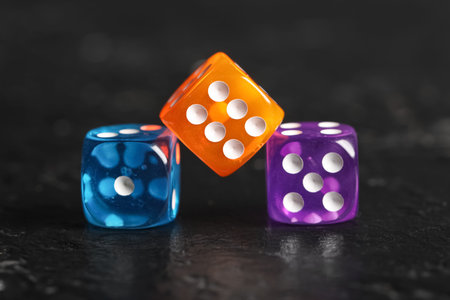Colorful game dices on black background