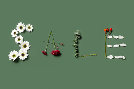 Word SALE made of beautiful spring flowers on green background