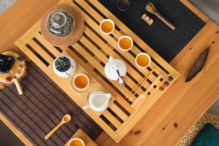 Asian tea set on table in living room, top view