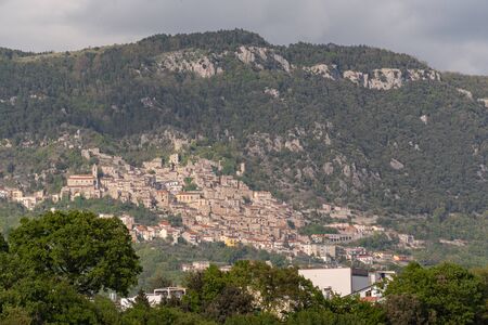 Panorama of Pesche, village in the province of Isernia, in Molise, perched along the steep slopes of Mount San Marco, a white spot against the green of the mountain and the gray of the stones.の写真素材