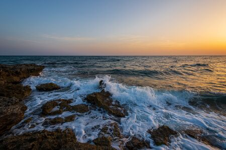 Adriatic sea. Ostuni, Puglia. Sunrise. Renowned seaside resort located in the heart of Salento. This stretch of coast is punctuated by a series of rocky beachesの写真素材