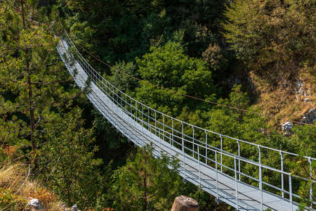A metal bridge suspended in the air, 234 meters long and reaching 140 meters above ground level, has been installed near the Roccamandolfi Castle for some years now.の写真素材
