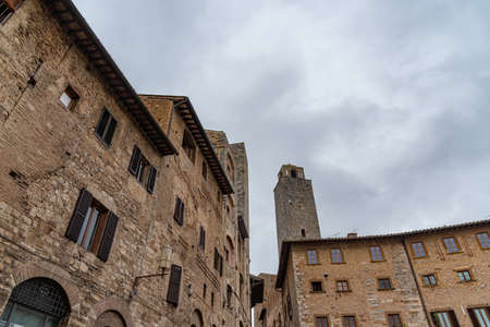 San Gimignano is a city in Tuscany. Surrounded by 13th century walls, the centerpiece of its historic center is Piazza della Cisterna. In the skyline of medieval towers stands the Torre Grossa in stone.の写真素材