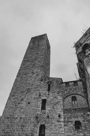 San Gimignano is a city in Tuscany. Surrounded by 13th century walls, the centerpiece of its historic center is Piazza della Cisterna. In the skyline of medieval towers stands the Torre Grossa in stone.の写真素材