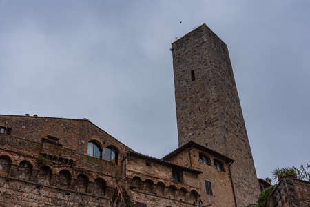 San Gimignano is a city in Tuscany. Surrounded by 13th century walls, the centerpiece of its historic center is Piazza della Cisterna. In the skyline of medieval towers stands the Torre Grossa in stone.の写真素材