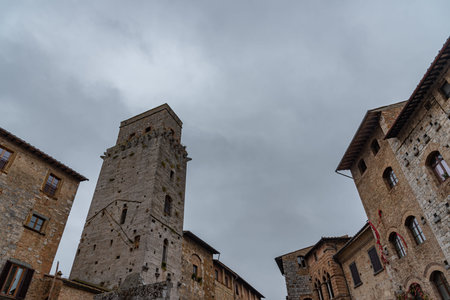 San Gimignano is a city in Tuscany. Surrounded by 13th century walls, the centerpiece of its historic center is Piazza della Cisterna. In the skyline of medieval towers stands the Torre Grossa in stone.の写真素材
