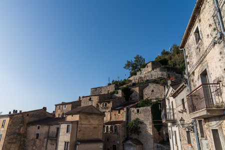 Pesche, village in the province of Isernia, in Molise, perched along the steep slopes of Mount San Marco, a white spot against the green of the mountain and the gray of the stones.の写真素材