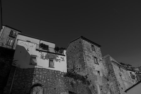 Pesche, village in the province of Isernia, in Molise, perched along the steep slopes of Mount San Marco, a white spot against the green of the mountain and the gray of the stones.の写真素材