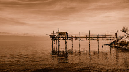 At the foot of the ancient village of Termoli, the Passeggiata dei Trabucchi winds its way, a stretch of coast from which it is possible to access the trabucchi, ancient fishing machines.の写真素材