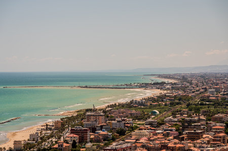 It rises on the shores of the Adriatic Sea and is located north of the mouth of the Tesino River. The town extends along the coast to the slopes of the surrounding hills.の写真素材