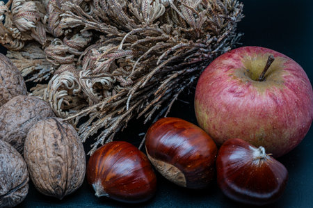 A composition of typically autumnal fruits such as chestnuts, walnuts or the Campanian Annurca apple, enhancing their beauty and detail.の写真素材